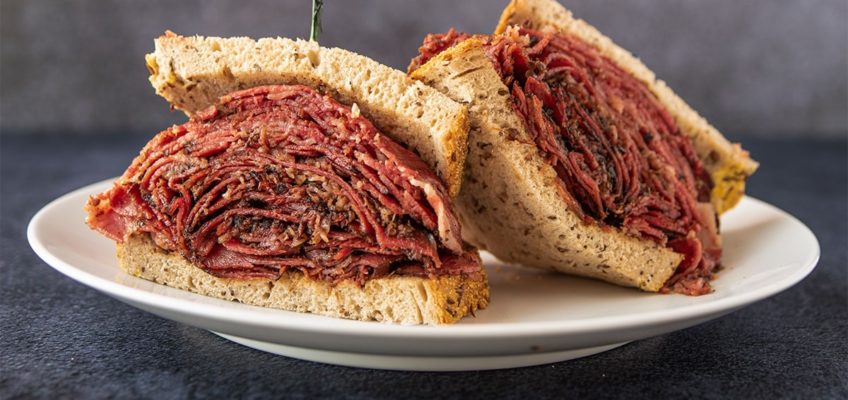 A plate of New York City Style Pastrami sandwich from Chompie's