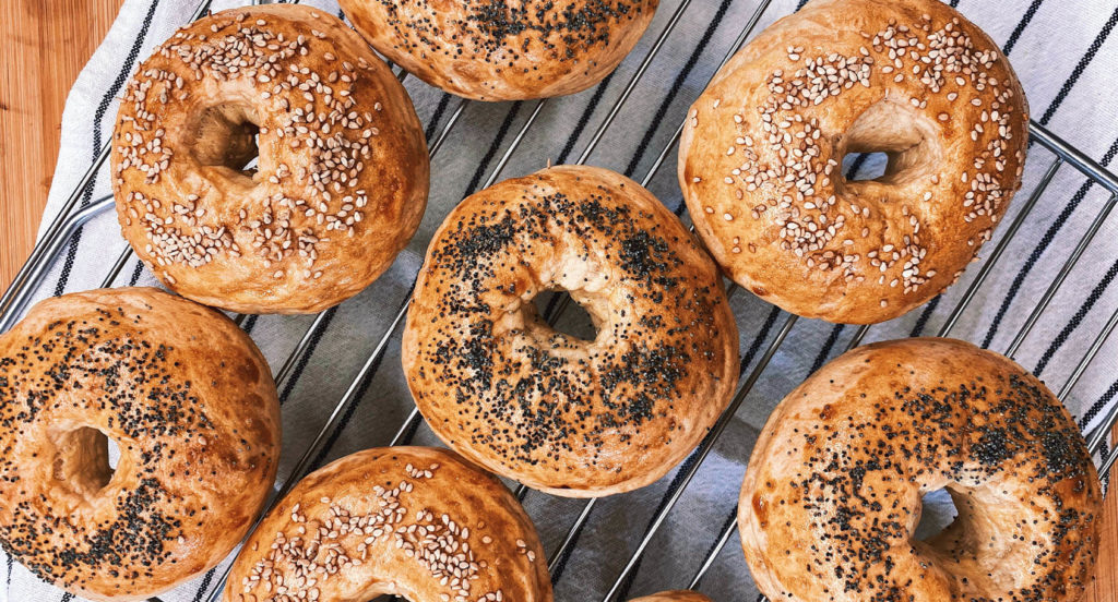 New York Style bagels resting on a baking rack