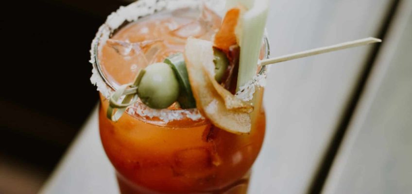 Bloody Mary with celery and olives outside